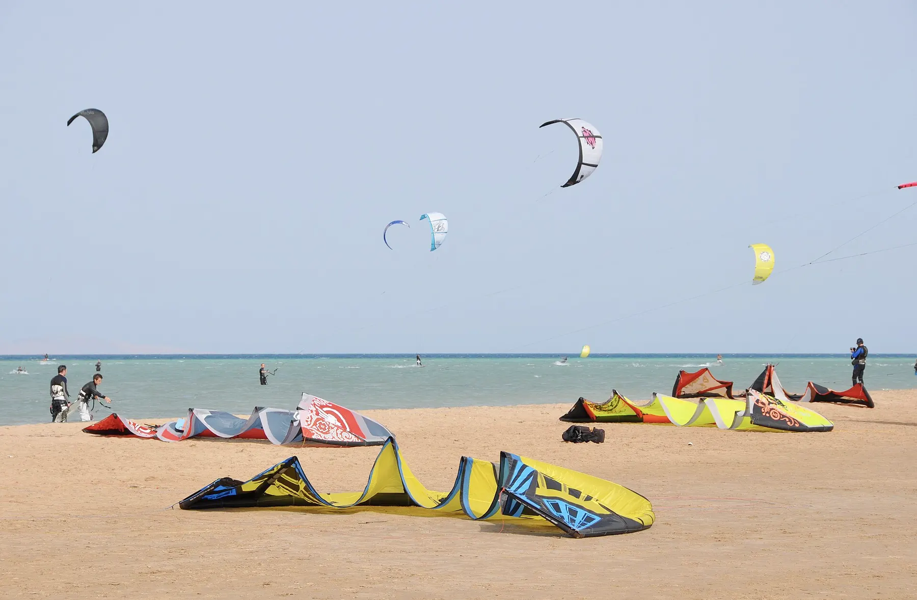 Kites laid out on the sand and kitesurfers on the water at Mangroovy Beach, El Gouna, in 2009.