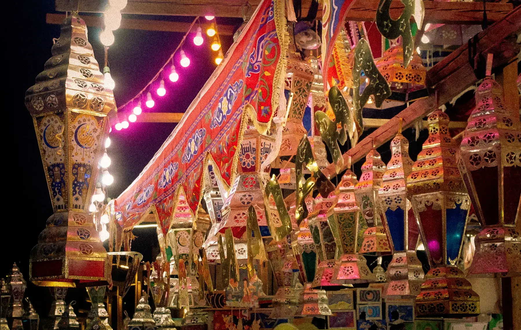 Ramadan lanterns and printed tent-cloth decorations hanging for sale in Sayeda Zeinab, Cairo.