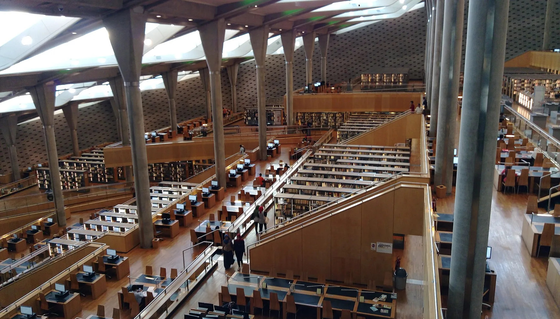 The tiered reading room of the Bibliotheca Alexandrina under its slanted roof.