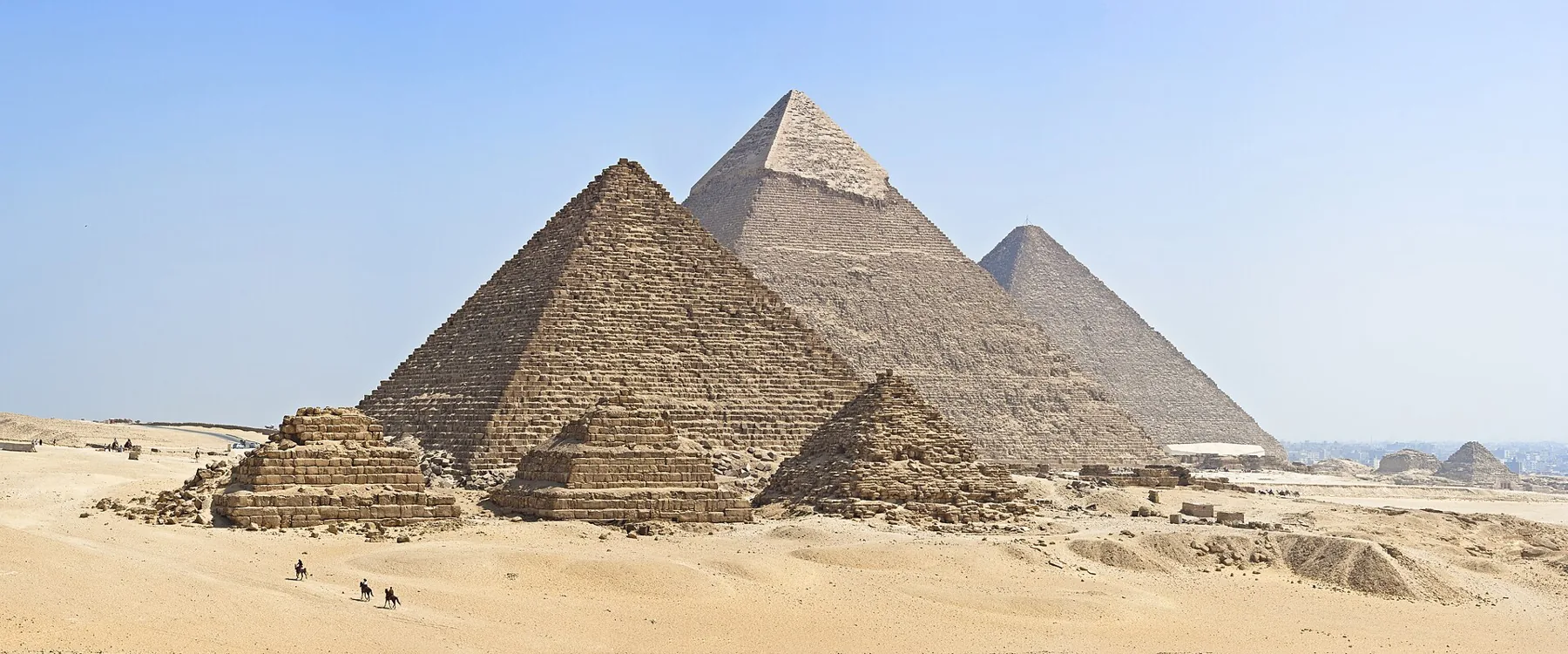 The three pyramids of Giza and the smaller queens' pyramids on the desert plateau.
