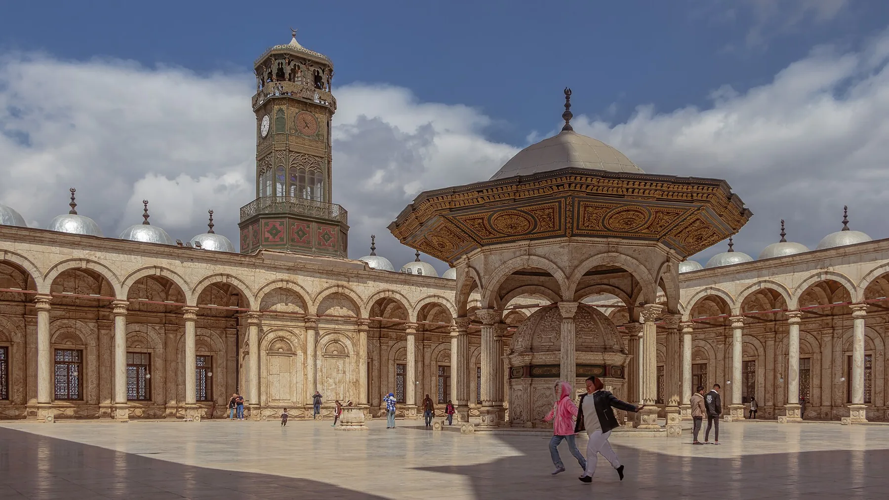 The arcaded courtyard of the Muhammad Ali Mosque, with its fountain and clock tower.