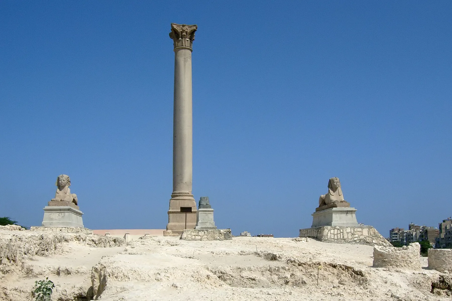 Pompey's Pillar standing between two sphinxes on the hill of the old Serapeum.