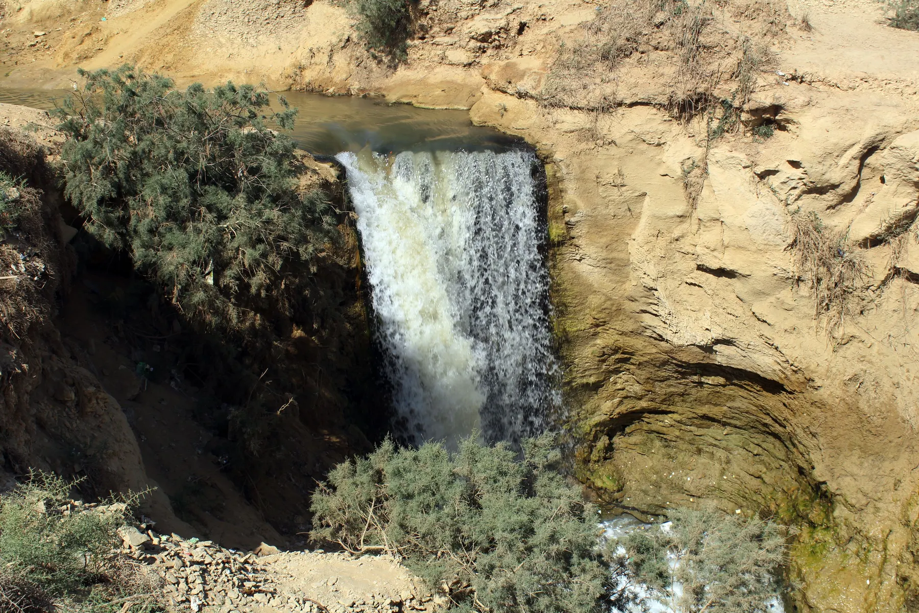 Water falling between rock ledges at the Wadi El Rayan waterfalls in Fayoum.